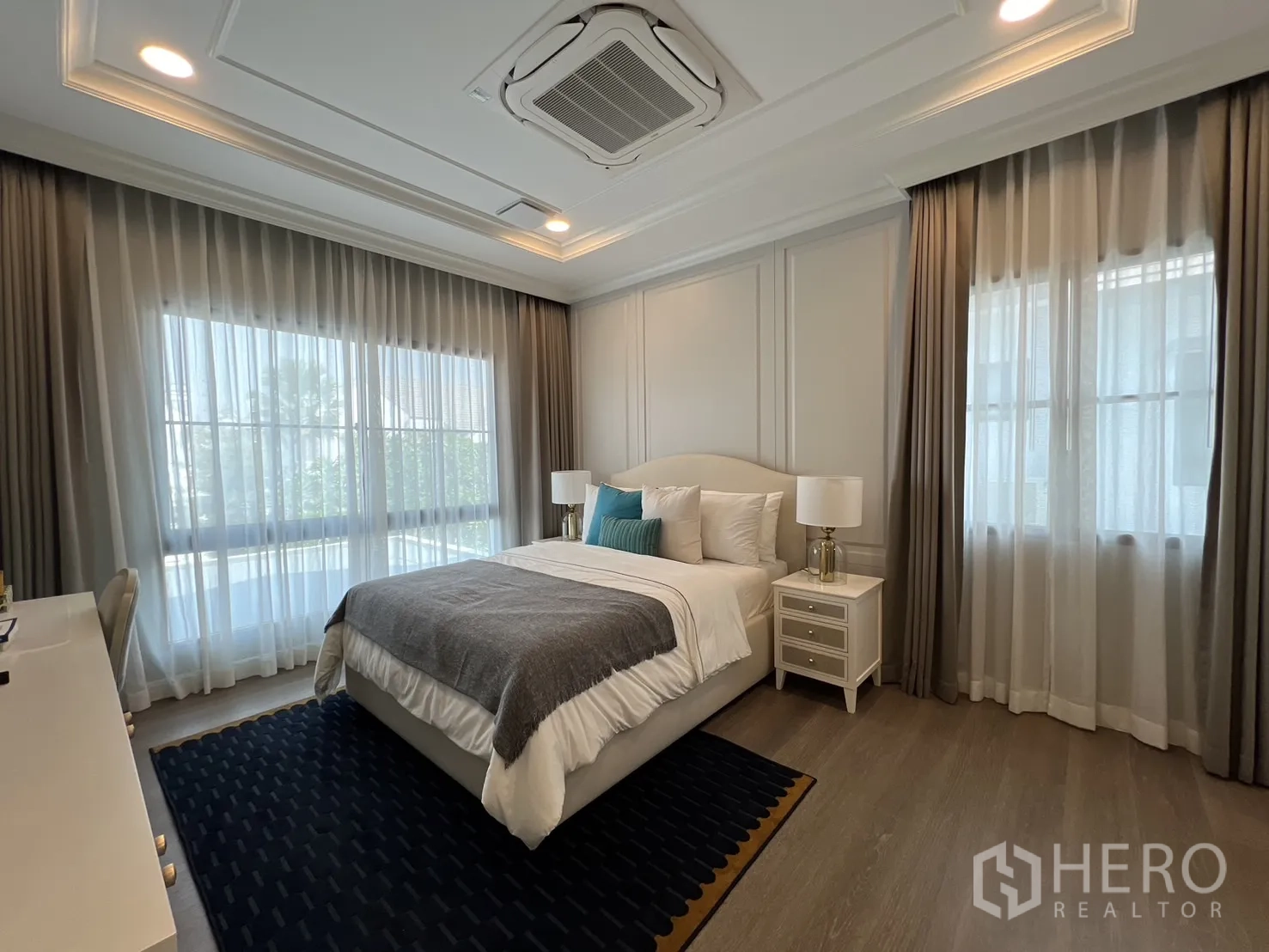 Detached House for rent in Saphan Sung, Bangkok - Second bedroom with large corner windows and soft drapes.