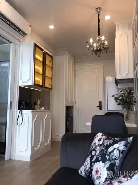 Condominium for rent in Watthana, Bangkok - Compact living area and pantry with classic white cabinetry and chandelier lighting
