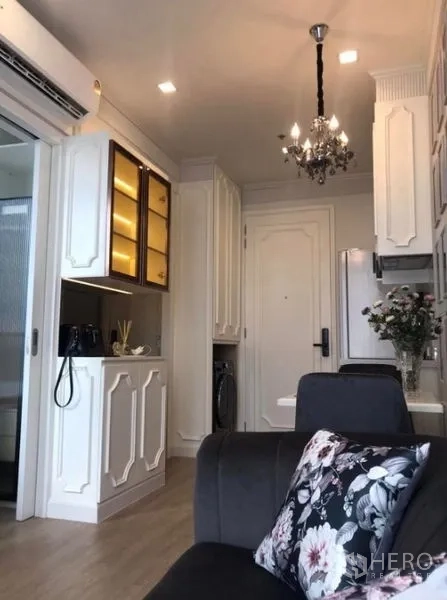 Condominium for rent in Watthana, Bangkok - Compact living area and pantry with classic white cabinetry and chandelier lighting