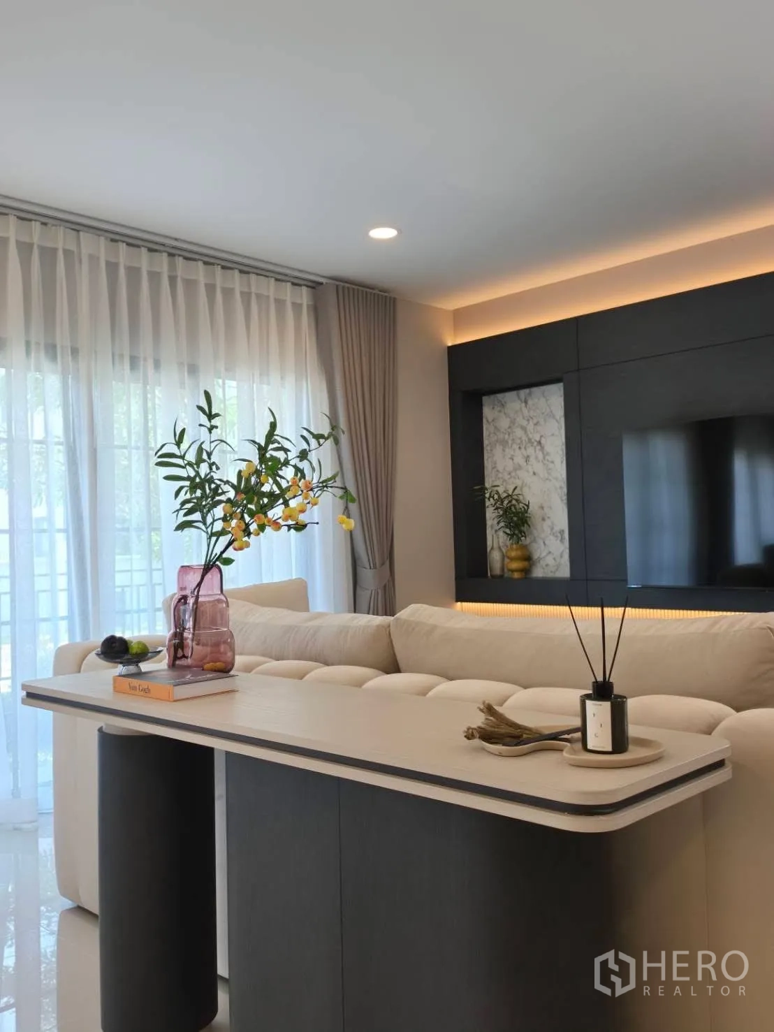 Detached House for rent in Bang Phli, Samut Prakan - Sofa table behind couch facing bright windows and TV wall.