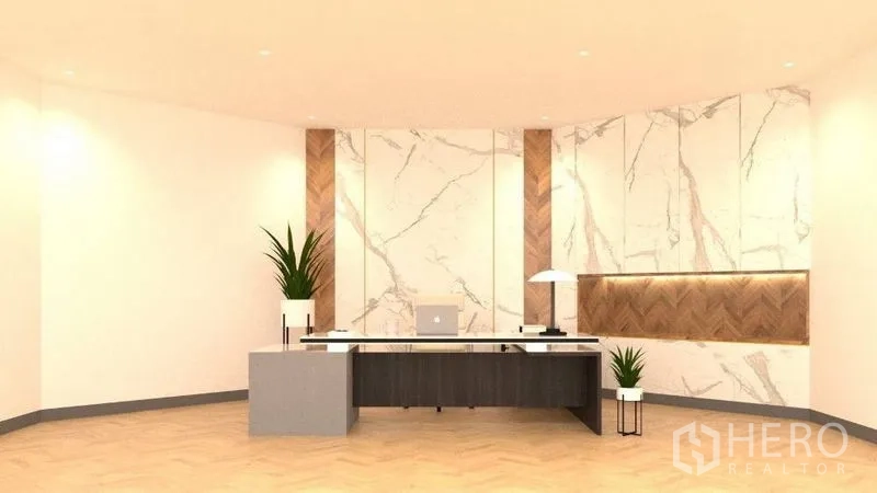 Detached House for rent in Lat Phrao, Bangkok - Stylish reception or home office featuring marble and herringbone wood accent wall, long desk and indoor plants.