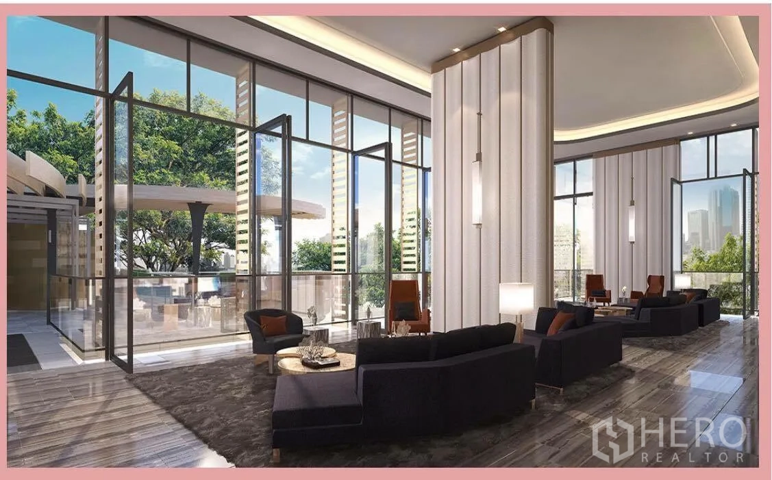Condominium for sale in Watthana, Bangkok - Residents’ lounge with double-height ceiling and full-height glass doors opening to the pool deck and city views.