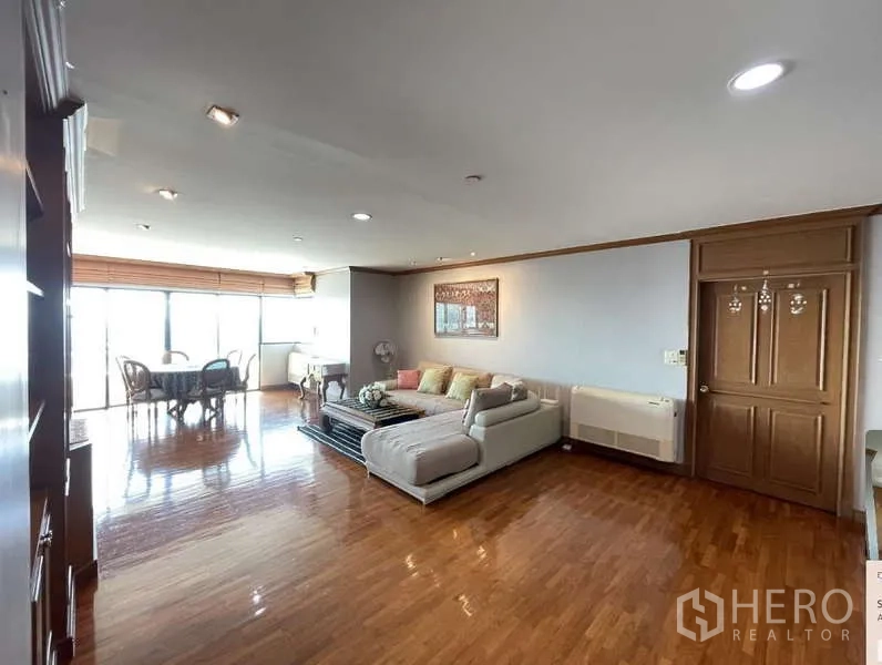 Condominium for rent - Open-plan living and dining space with sofa set and balcony access via sliding doors.