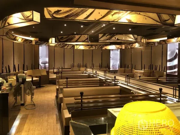 Retail Space for rent in Khlong Toei, Bangkok - Spacious dining hall with booth seating, wood floors and sculptural ceiling lights.