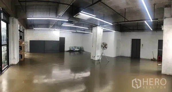 Office Space for rent in Khlong Toei, Bangkok - Panoramic view of empty office space with polished floors, exposed ducting, a support column and multiple access doors