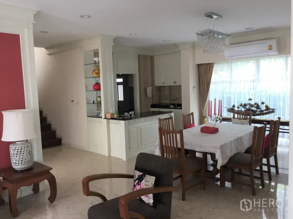 Detached House for rent in Saphan Sung, Bangkok - Bright dining area beside the kitchen with marble floors, large windows and a crystal chandelier.