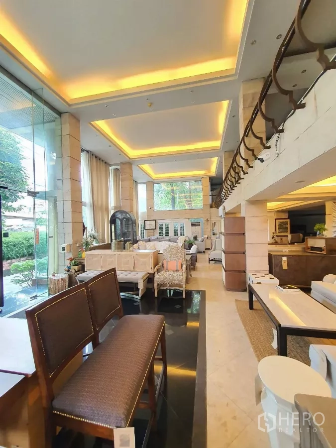 พื้นที่ขายปลีก ให้เช่าในWang Thonglang, Bangkok - โชว์รูมเพดานสูงพร้อมไฟซ่อนประดับ ทางเข้าแก้ว คอลัมน์หิน และกระจกบานใหญ่เห็นวิวสวน