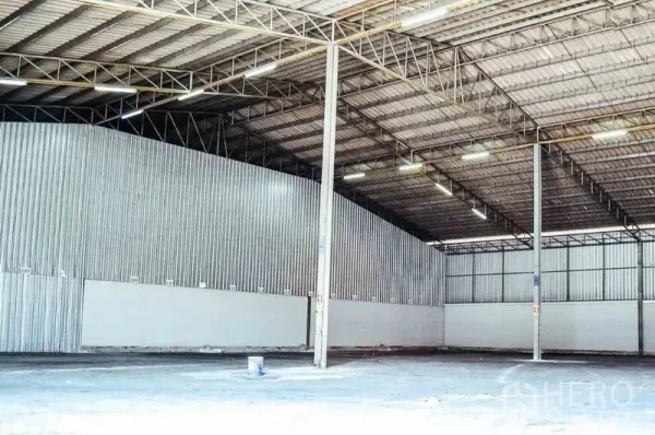 Warehouse for rent in Bang Sao Thong, Samut Prakan - Spacious warehouse interior with high clear-span steel roof, bright lighting, and open floor.