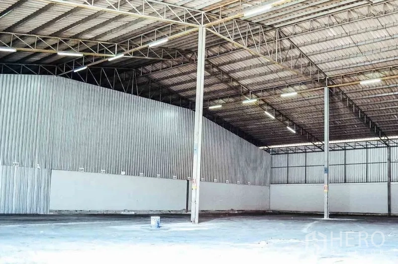 Warehouse for rent in Bang Sao Thong, Samut Prakan - Spacious warehouse interior with high clear-span steel roof, bright lighting, and open floor.