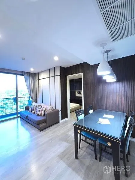 Condominium for rent - Bright living–dining space opening to a balcony with city views.