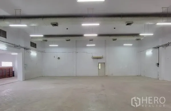 Warehouse for rent in Sam Phran, Nakhon Pathom - High-ceiling warehouse interior with ducted ventilation and bright LED lighting.