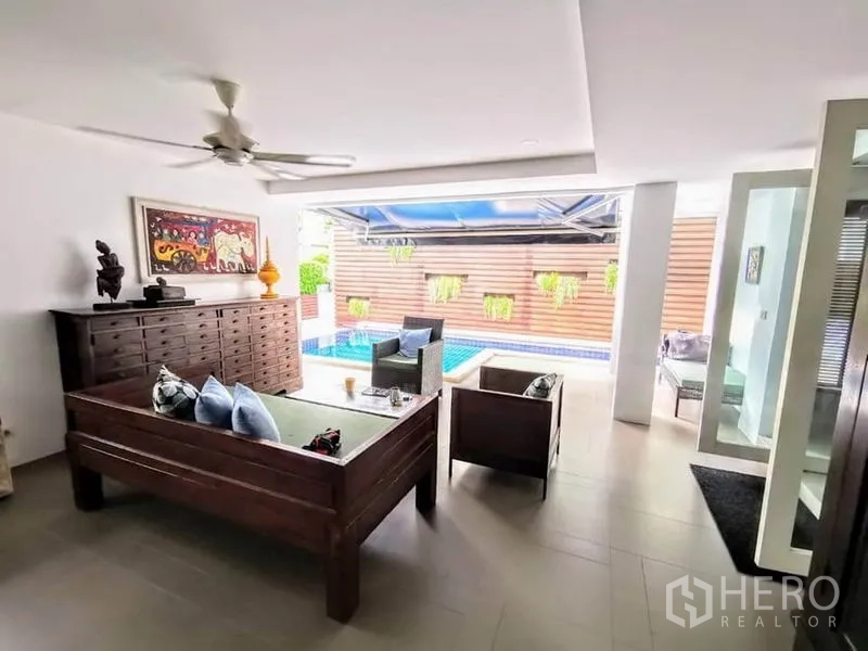 Detached House for rent or sale in Bang Phli, Samut Prakan - Shaded living area opening to patio with view of blue-tiled swimming pool.