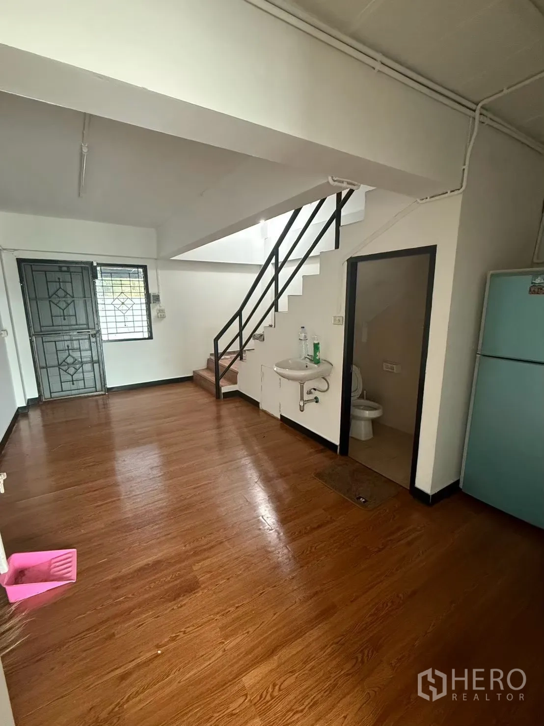 Shophouse for rent in Pak Kret, Nonthaburi - Rear ground floor with staircase, sink, and guest restroom.