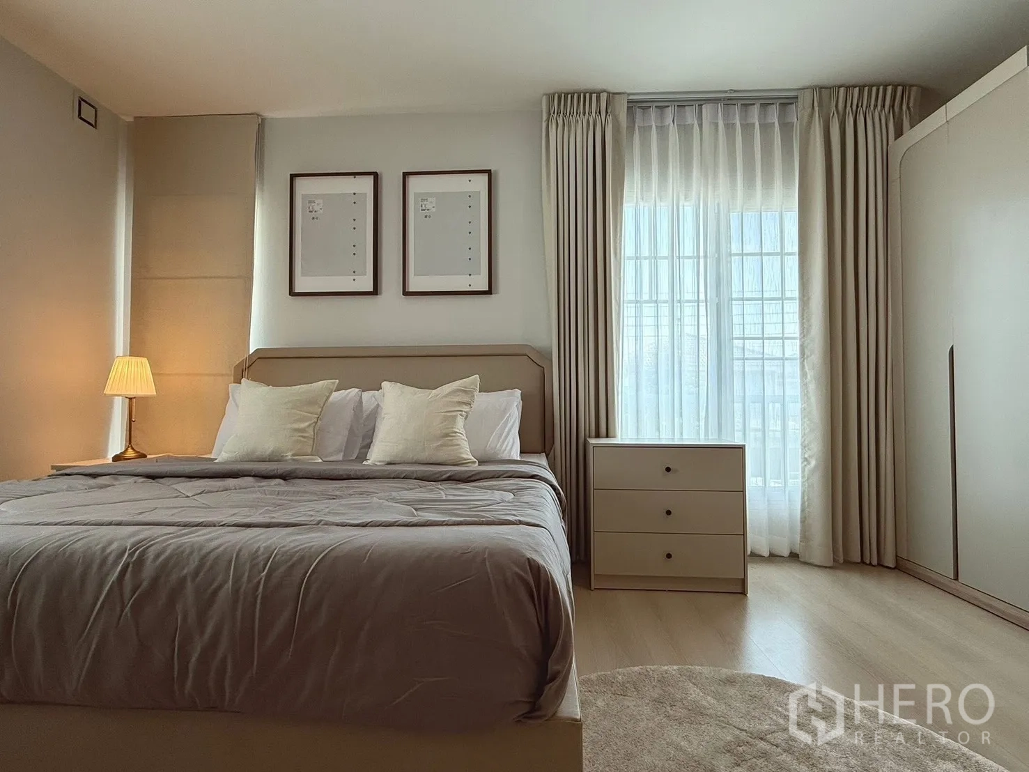 Detached House for rent in Bang Phli, Samut Prakan - Spacious bedroom with large window, bedside lamp, and wardrobe.