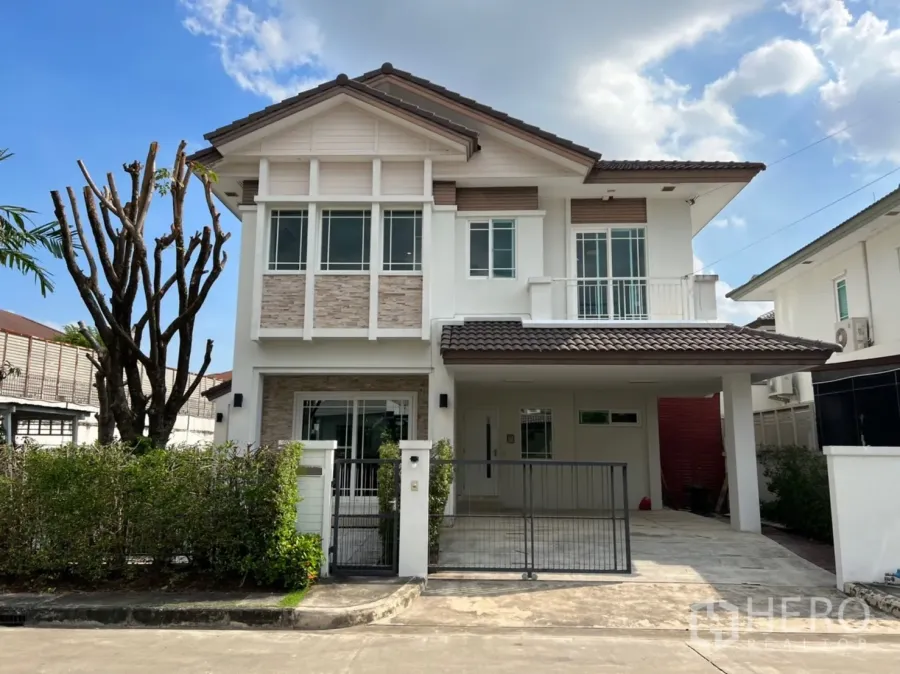Detached House for rent in Bang Kapi, Bangkok - Two‑storey detached house facade with gated driveway, carport, and white exterior walls.