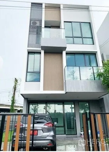 Home Office for rent in Don Mueang, Bangkok - Modern three-storey home office facade with balconies, glass frontage and gate.