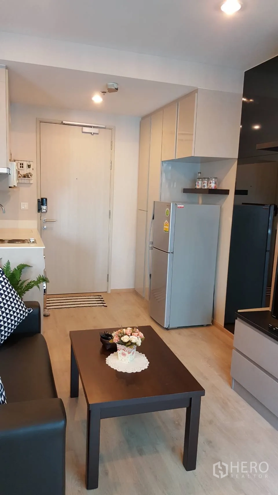 公寓 出租在Bang Rak, Bangkok - 紧凑厨房，充足柜体和双门冰箱，靠近玄关。