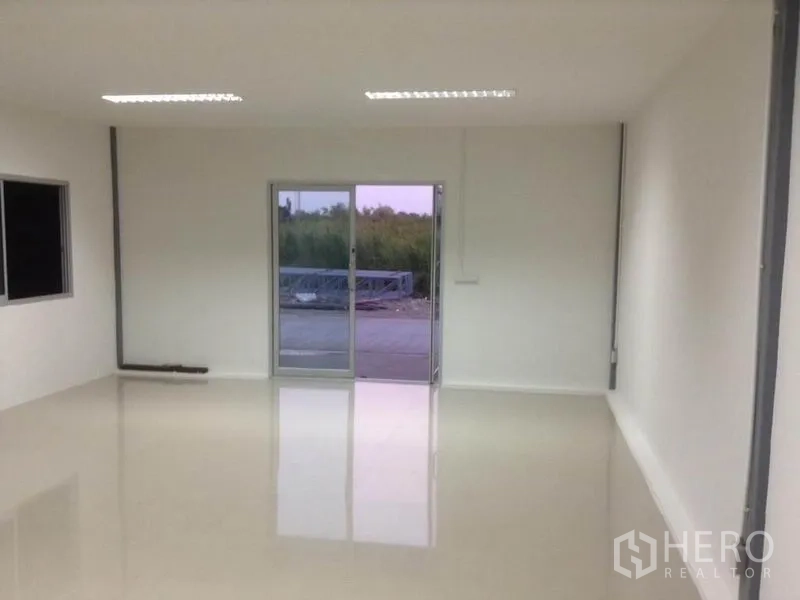 Warehouse for rent in Bang Kapi, Bangkok - Bright white office room inside the warehouse with glossy floor, sliding glass door and ceiling lights.