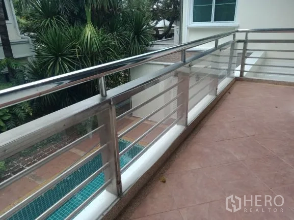 Detached House for rent in Bang Rak, Bangkok - Tiled balcony with stainless-steel railing overlooking the pool and garden.