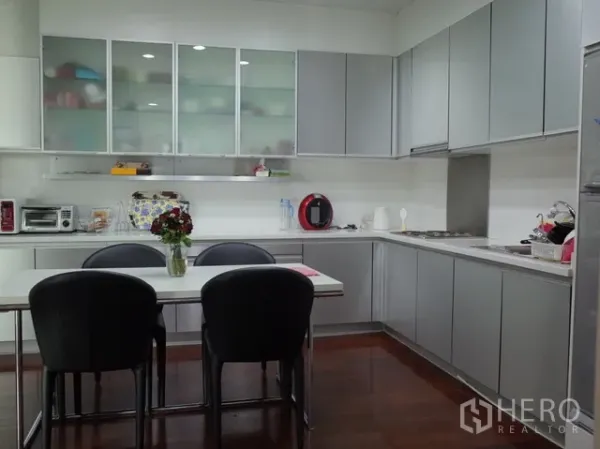 公寓 出售在Watthana, Bangkok - 现代白灰色厨房，带餐桌、嵌入式柜体与电器的两卧公寓