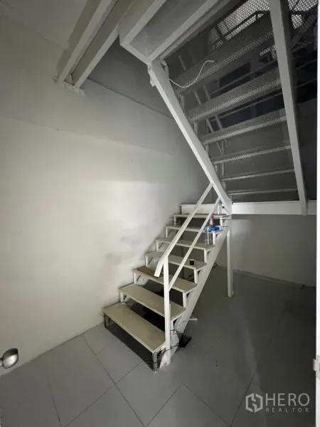 Shophouse for rent or sale in Khlong Toei, Bangkok - White metal staircase leading to upper levels inside the shophouse.
