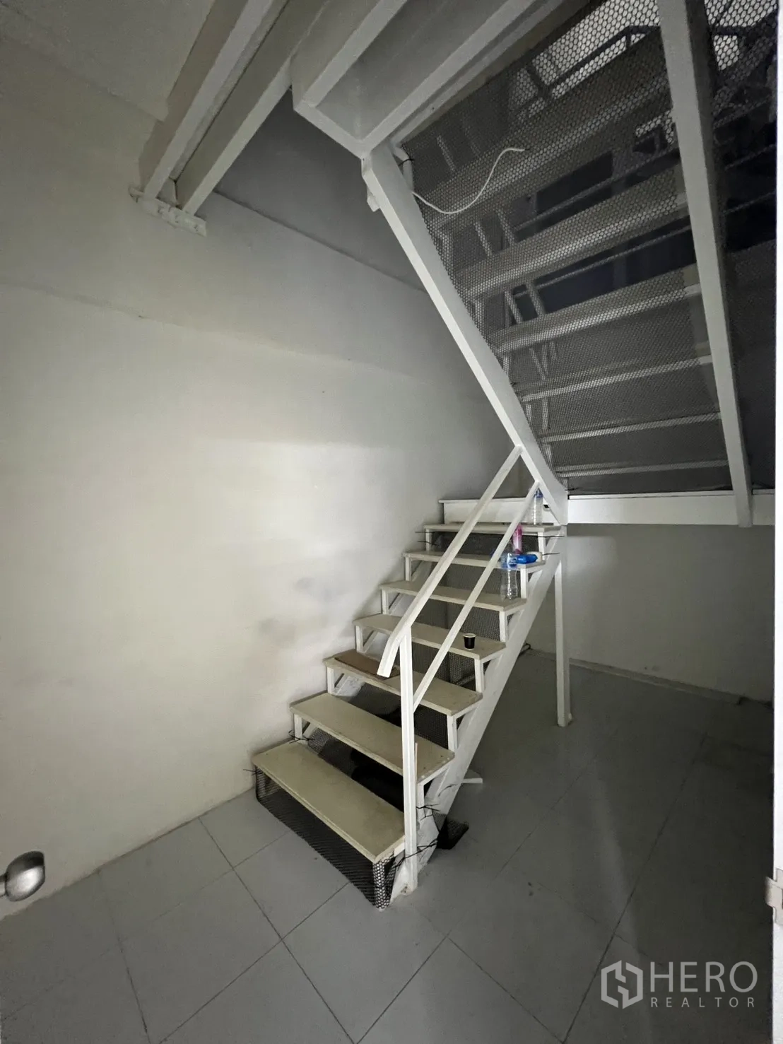 Shophouse for rent or sale in Khlong Toei, Bangkok - White metal staircase leading to upper levels inside the shophouse.