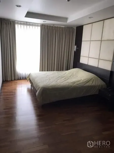 公寓 出租在Watthana, Bangkok - 第二卧室，木地板、软包床头墙，大窗配窗帘，陈设简约。