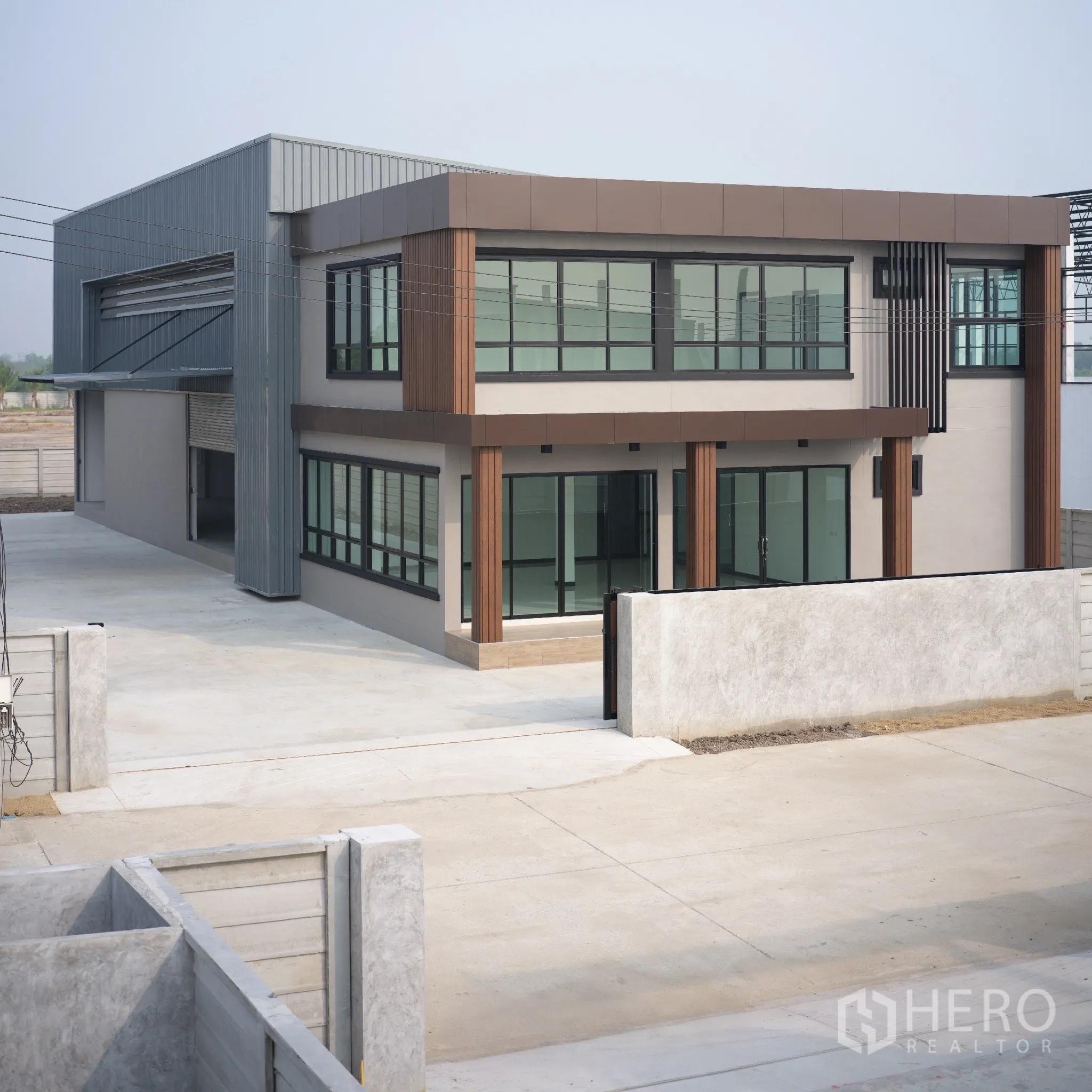 Factory for rent or sale in Bang Len, Nakhon Pathom - Modern two-storey office building attached to the factory within a gated compound.