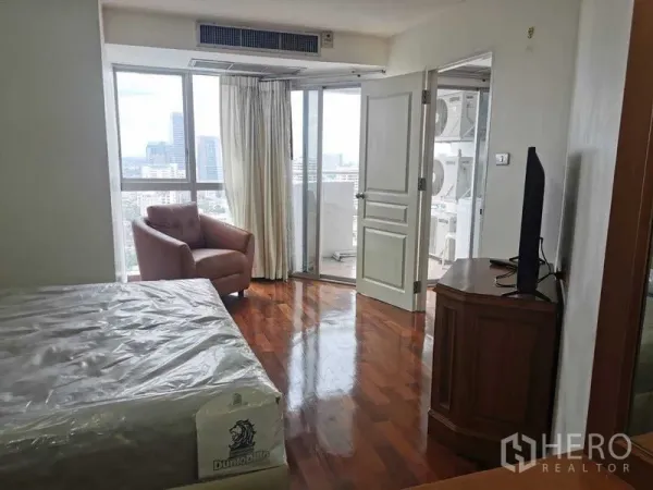 Condominium for rent - Bedroom corner facing the balcony with large windows bringing in natural light.