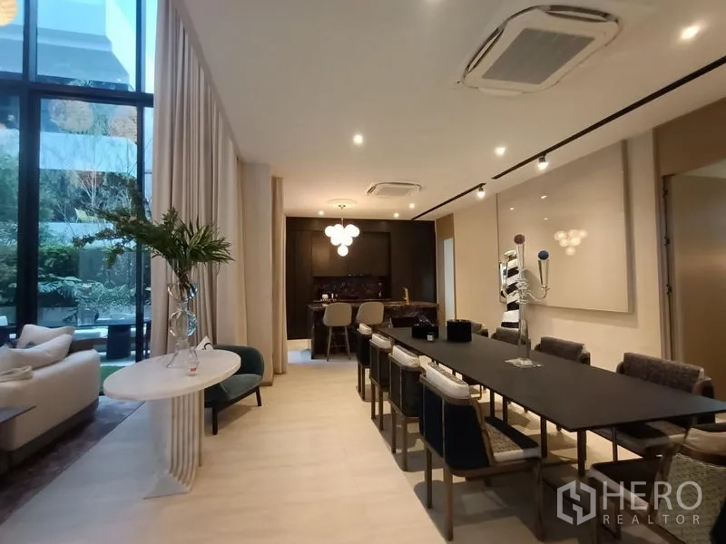 Detached House for sale - Long dining area with large table, pantry bar and tall windows with drapes.