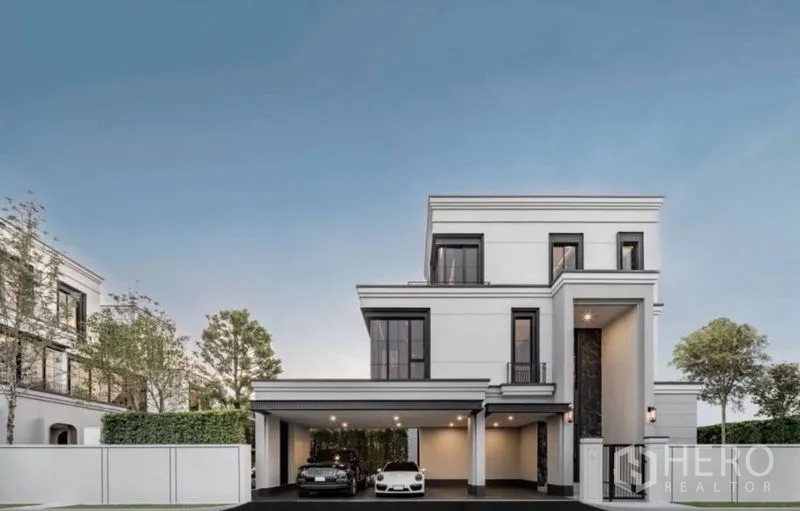 Detached House for rent - Front elevation of the three-storey detached house with carport and trimmed fence.