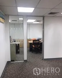 Office Space for rent in Khlong Toei, Bangkok - Entrance to a private office with a glass door, carpet flooring and office chair inside.