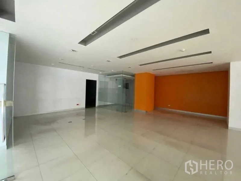 Retail Space for rent - Modern corner exterior with wraparound glass facade and landscaped verge.