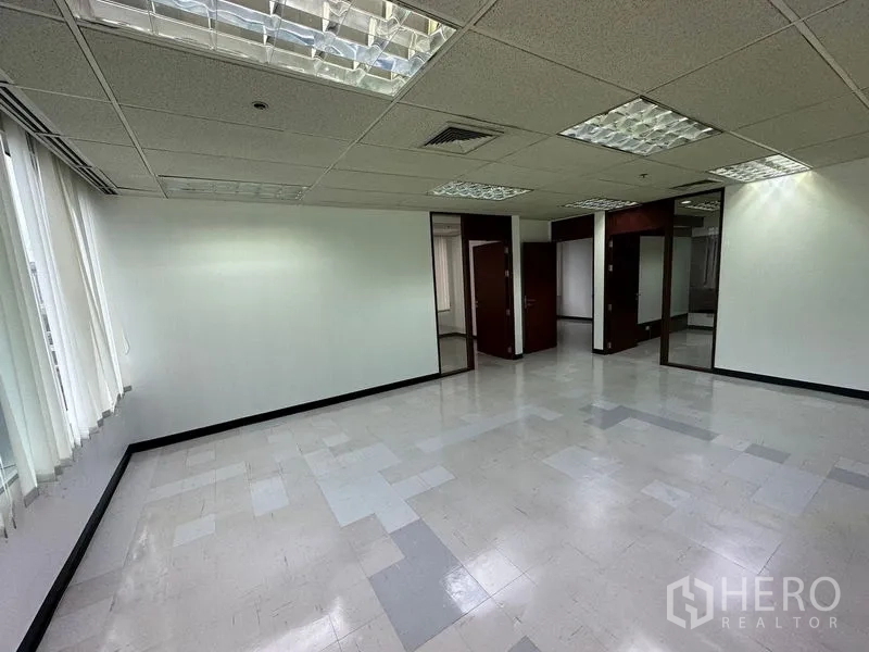 Office Space for rent in Chatuchak, Bangkok - Bright open office area with drop ceiling lights and multiple partitioned doorways.