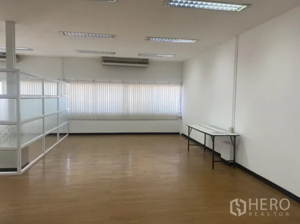 Office Space for rent in Khlong Toei, Bangkok - Spacious office area with a long window wall, air-conditioning units, and a glass-partitioned meeting zone.