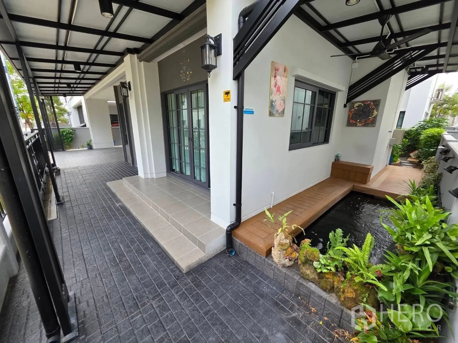 独栋房屋 for rent or sale in Bang Phli, Samut Prakan - 遮荫露台旁的锦鲤池与绿植景观。