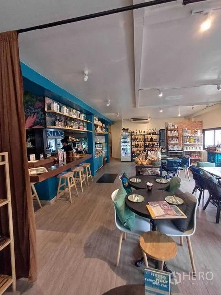 Retail Space for rent in Watthana, Bangkok - Cafe-style seating area beside blue bar and display shelving.