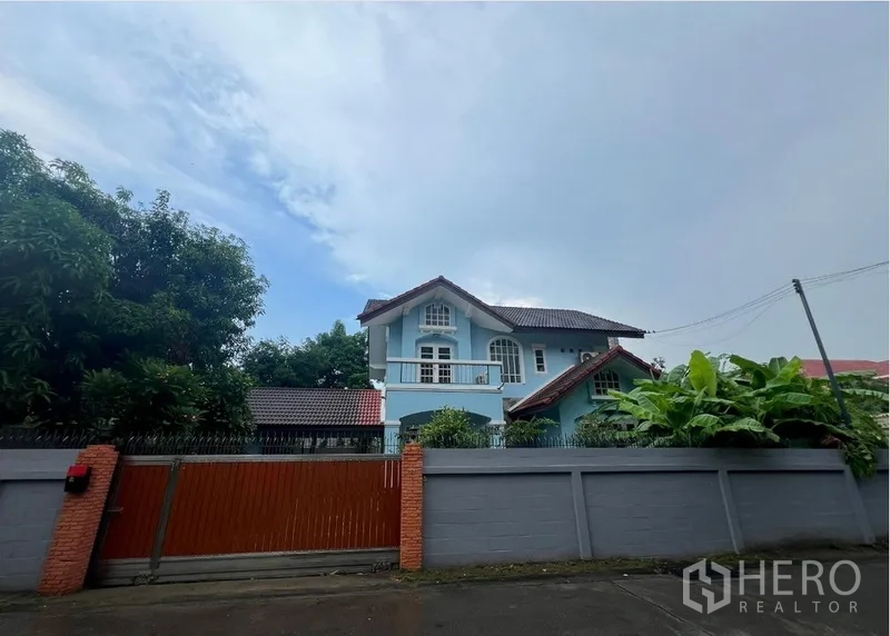 บ้าน ให้เช่าในBang Na, Bangkok - บ้านเดี่ยวสองชั้นสีฟ้า หลังรั้วปูนและประตูไม้บนถนนเงียบสงบ