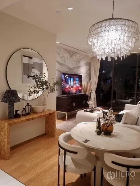 Condominium for sale - Warm living and dining room with chandelier, round mirror, wood floors and balcony glazing.
