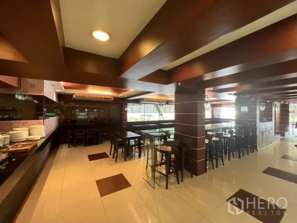 Retail Space for rent or sale in Khlong Toei, Bangkok - Spacious dining hall featuring tiled floors, wooden beams and multiple seating areas.