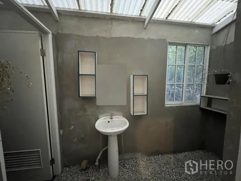 Shophouse for rent or sale in Watthana, Bangkok - Wash area with pedestal sink, window and open shelving.