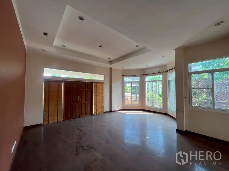 Detached House for rent in Watthana, Bangkok - Front lounge with bay windows, wooden double doors and a tray ceiling.