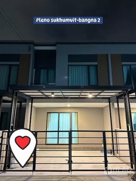 Townhouse for rent in Bang Phli, Samut Prakan - Night view of the Pleno Sukhumvit–Bangna 2 townhouse facade with a covered double carport and metal gate.