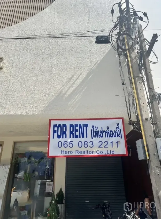Retail Space for rent in Watthana, Bangkok - Ground-floor shopfront with FOR RENT sign, rolling shutter, glass window and street power lines.