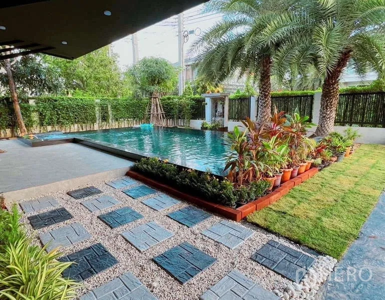 Detached House for rent or sale in Bang Phli, Samut Prakan - Landscaped garden with stepping stones beside a rectangular private pool.