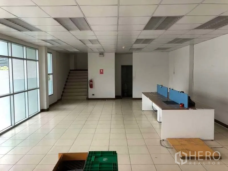 Factory for rent in Bang Sao Thong, Samut Prakan - Ground-floor office lobby with stairs, tiled floor and frosted glass panels.