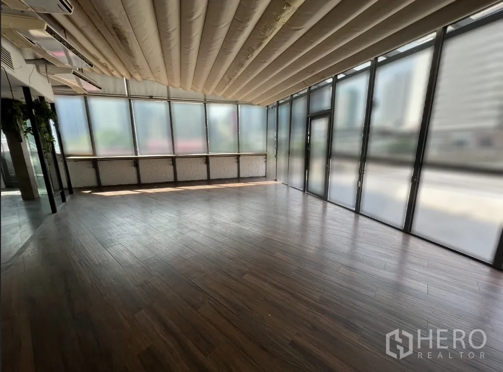 Retail Space for rent in Pathum Wan, Bangkok - Finished retail area with wood flooring, full-height glazing, and fabric ceiling baffles.