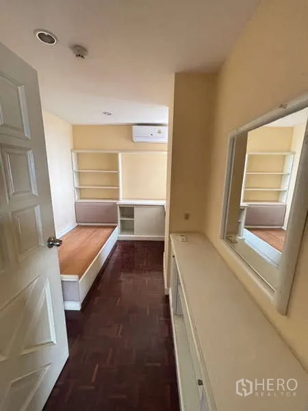 Condominium for rent - Third bedroom with built-in storage, vanity counter and wall-mounted air conditioner.