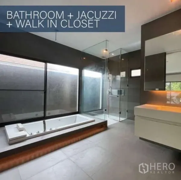 Detached House for sale in Khlong Toei, Bangkok - Spacious bathroom featuring a built-in jacuzzi, glass shower enclosure, large windows and vanity.