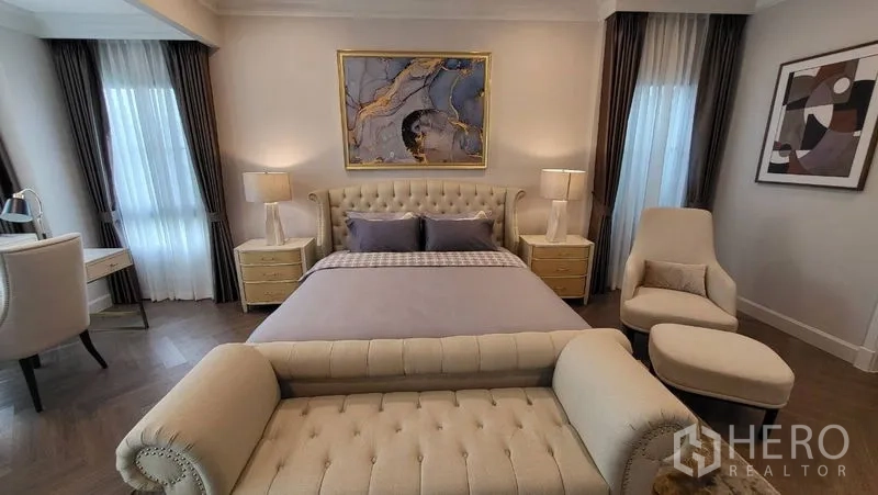 Detached House for rent or sale in Saphan Sung, Bangkok - Master bedroom angle showing tufted headboard, bedside tables and wall art.